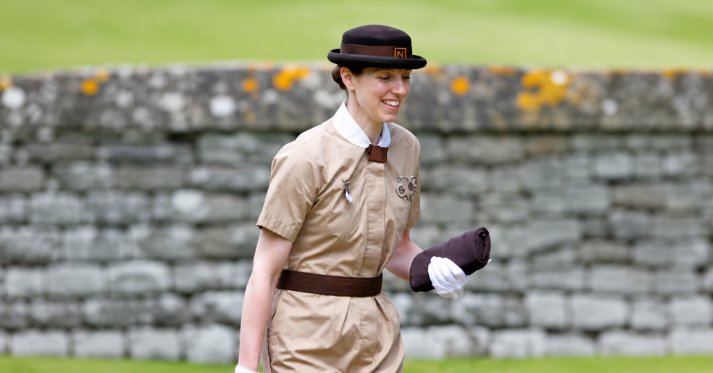 Kate and William's nanny receives recognition for outstanding childcare service while attending a formal award ceremony, dressed in a professional uniform.